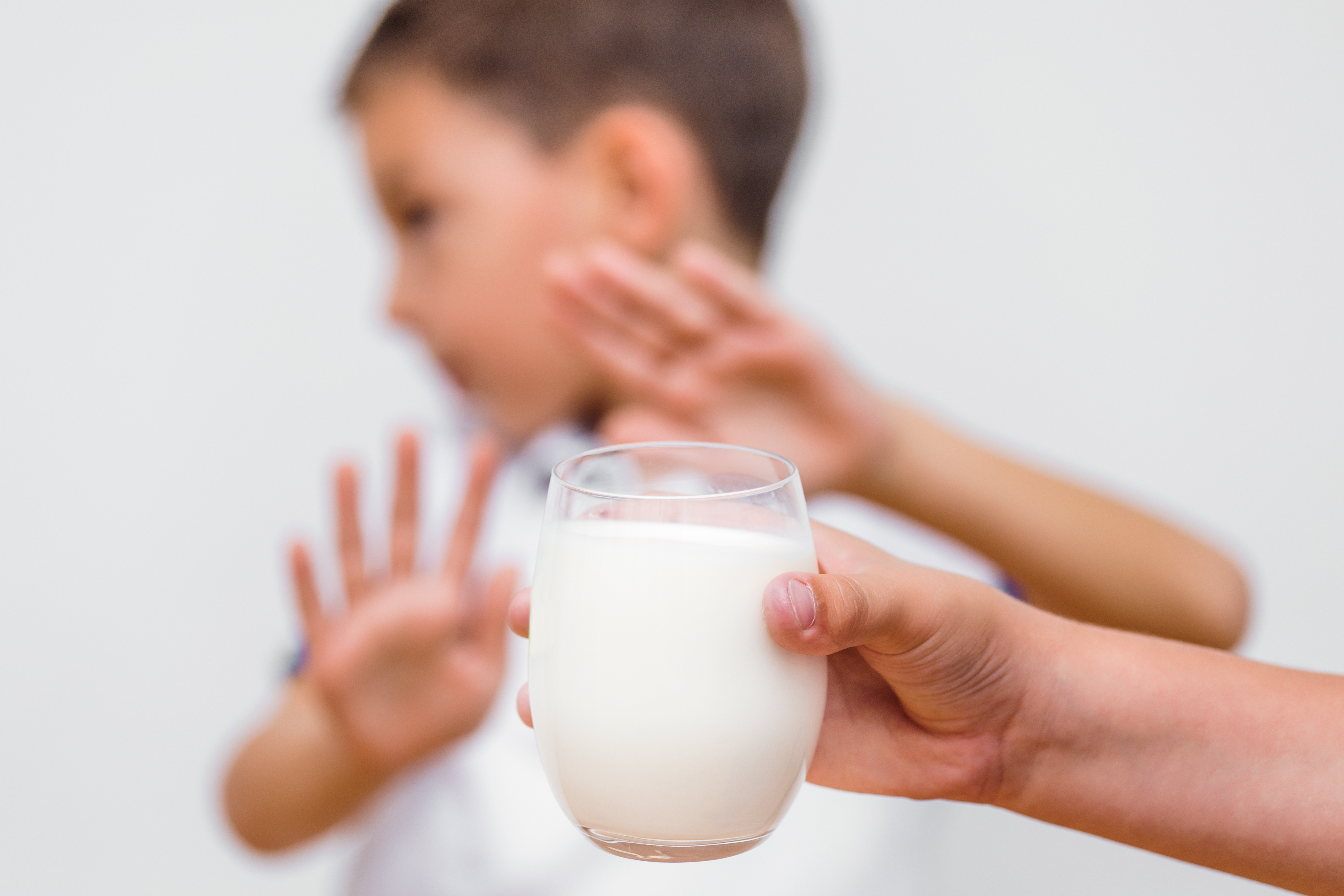 lactose intolerance or food allergy in children blog image of a child refusing to drink milk